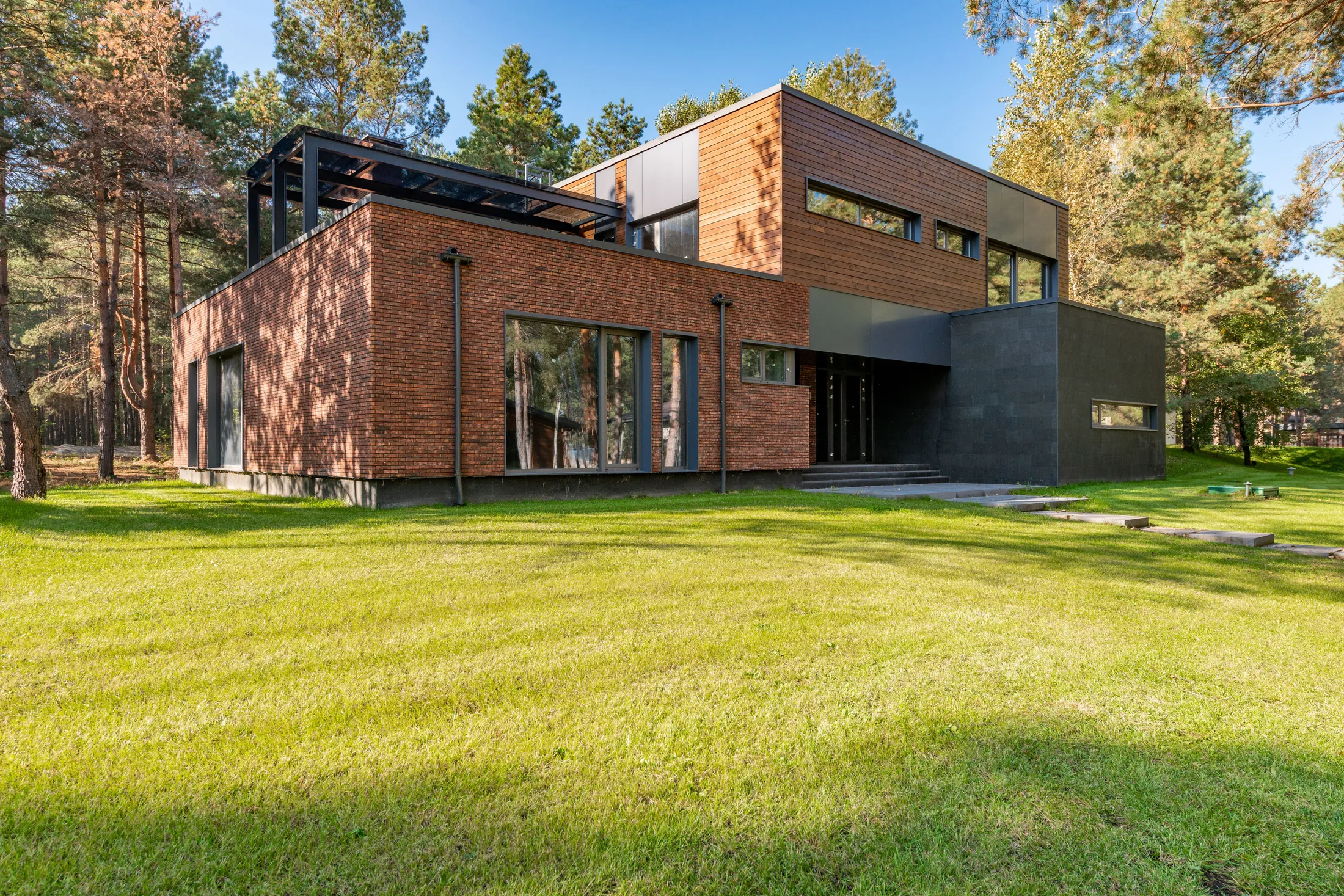 The Brickworks House, its brick and glass elevation against the lawn