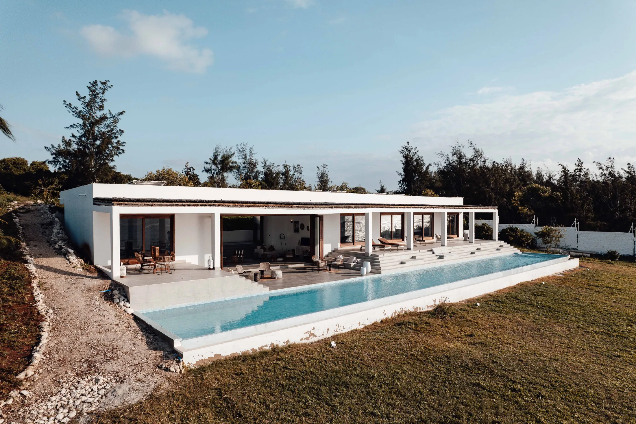 The Long House seen along its infinity pool with the sea beyond