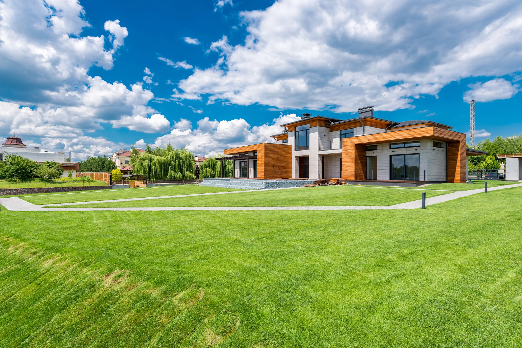 A completed Garden House with timber walls and an open lawn