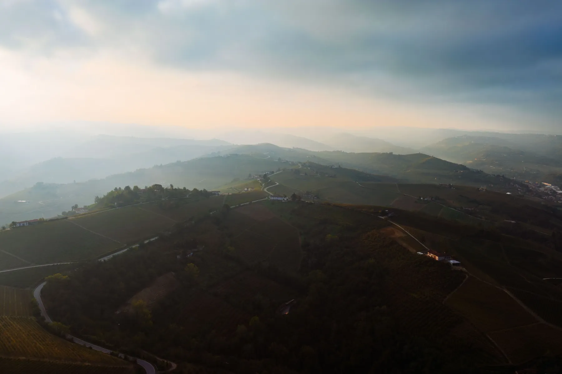 Rolling vineyard hills under a low evening light