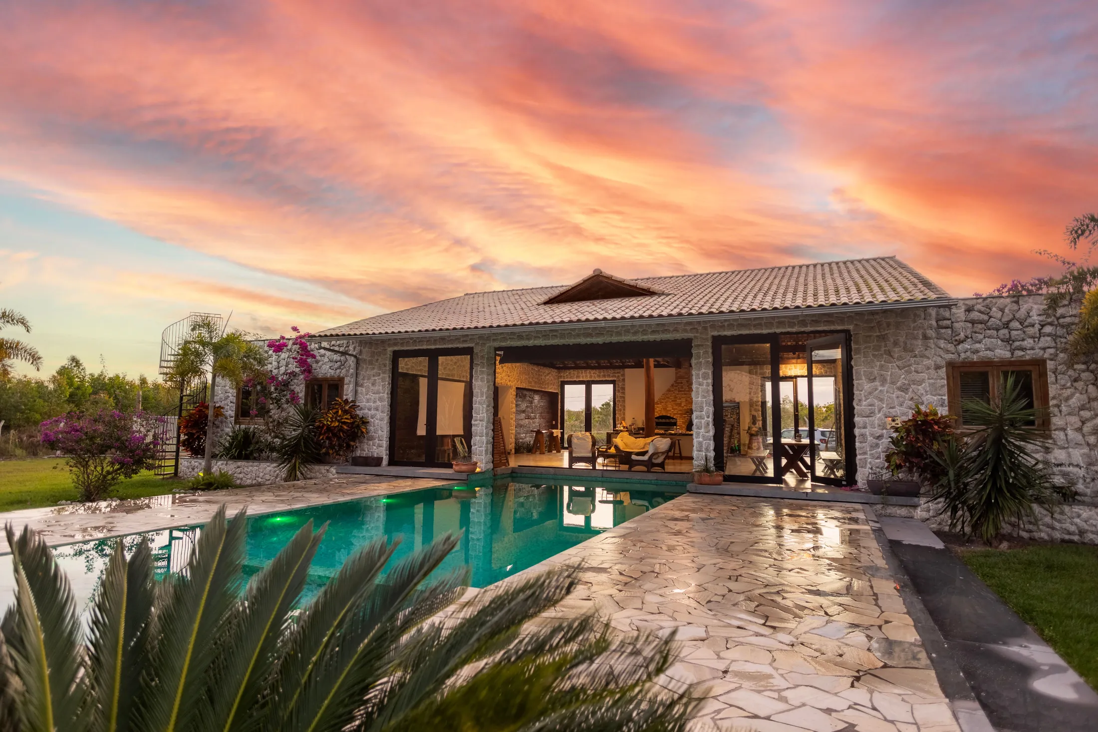 Villa Auvinel with its pool below the loggia at sunset